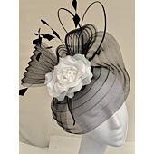 Black and white fascinator, with a soft rose fine feathers and quills