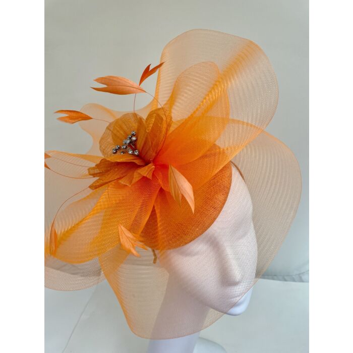 Orange fascinator with flower and feathers